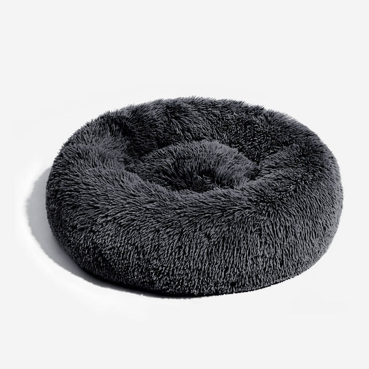 Round plush dog bed, grey, offering warmth and anxiety relief for pets