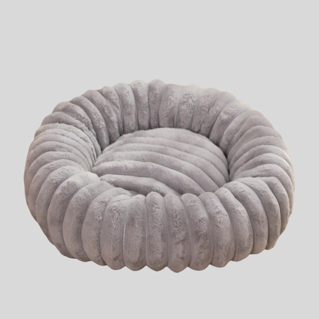 Soft pet bed with a cozy, washable grey cover, designed for ultimate dog comfort.