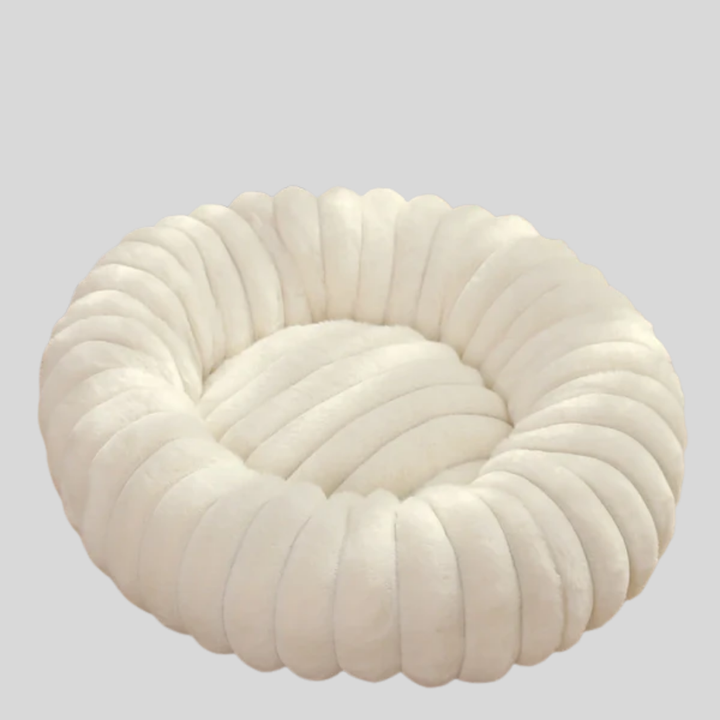 Cozy pet bed in a neutral tone with a plush interior and durable, washable design.