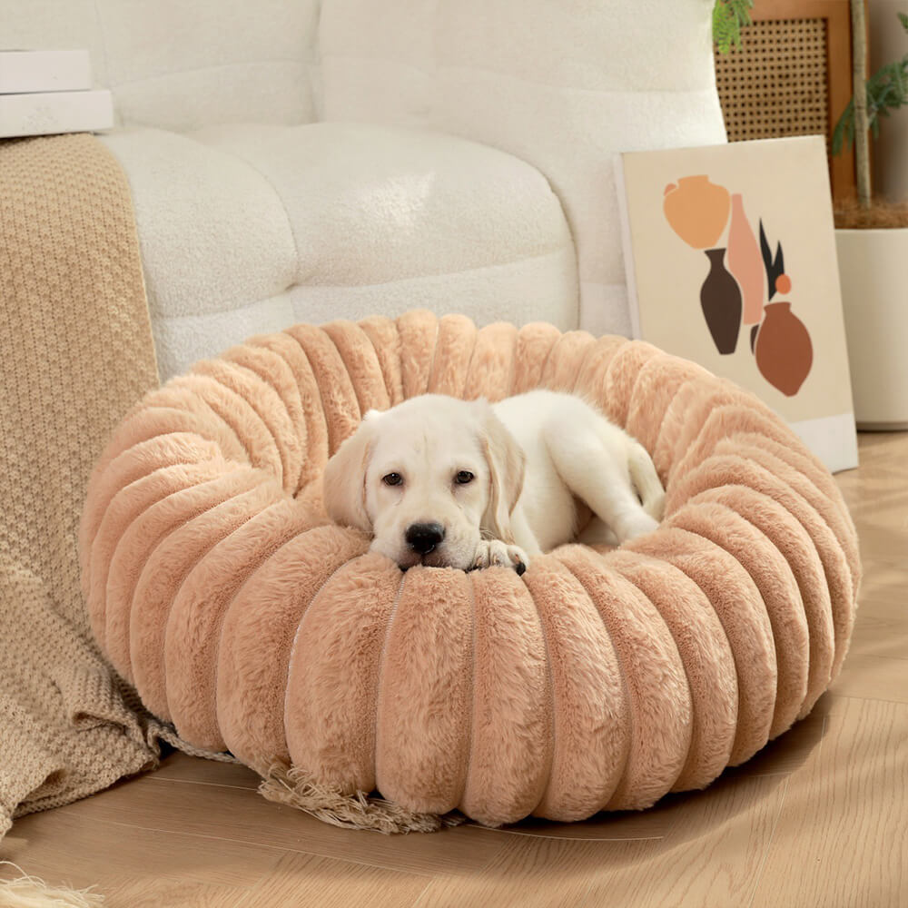 Cream-colored round pet donut bed, a plush and comfortable calming dog bed.
