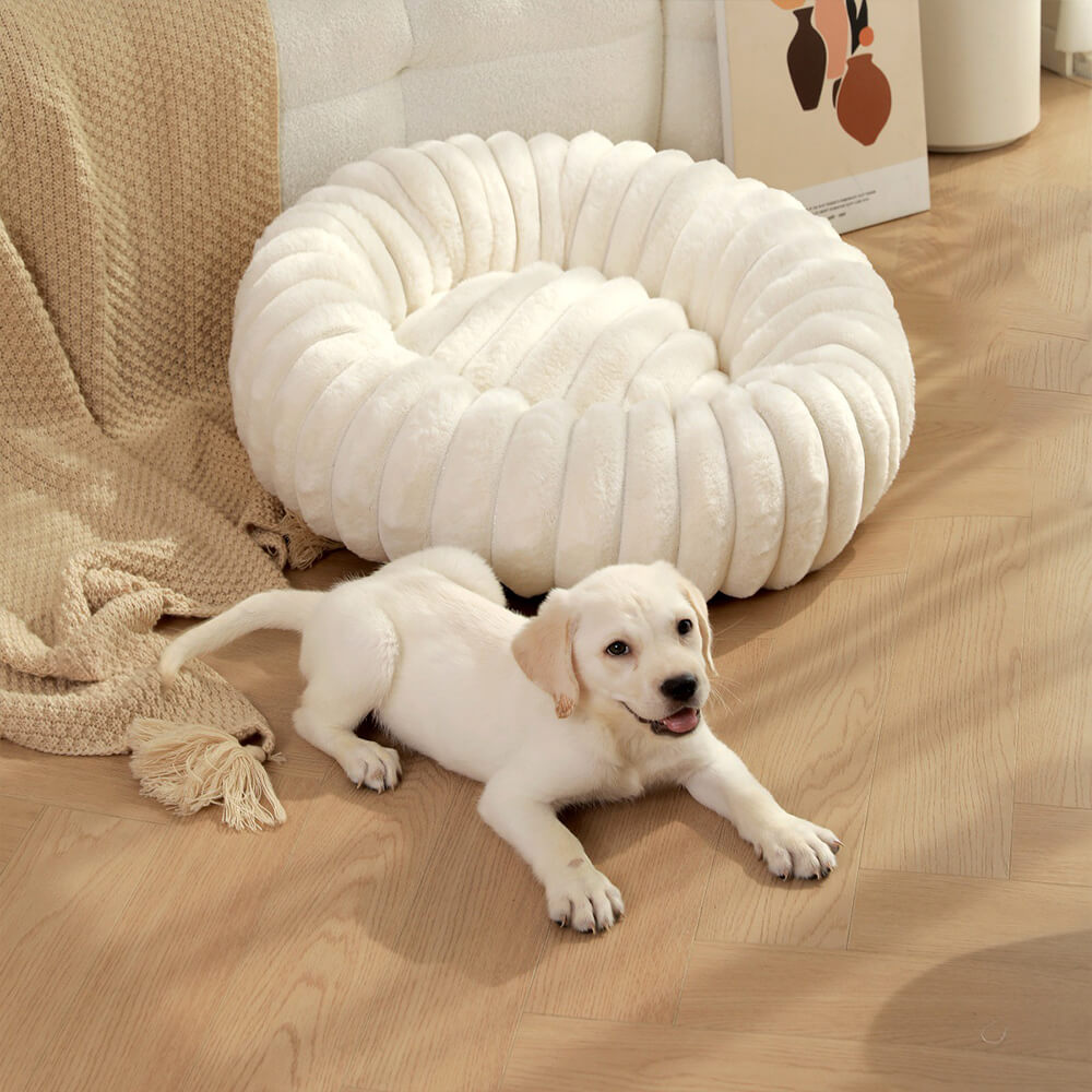 Plush round cat bed in a neutral tone, a soft and calming donut pet bed.