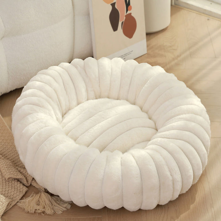 Donut-shaped pet bed in brown plush fabric, a cozy and calming bed for dogs and cats.