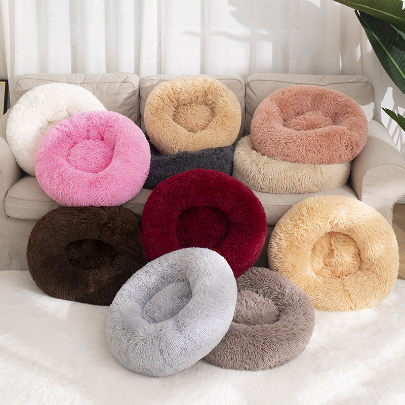 Soft donut-shaped calming pet bed in beige, ideal for cats and small dogs