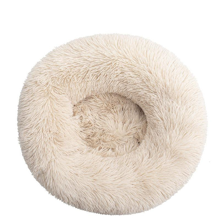 Close-up of fluffy texture of a unisex calming cat bed, promoting deep sleep