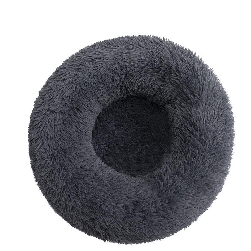 Small pet snuggled in a cozy plush donut bed, demonstrating comfort