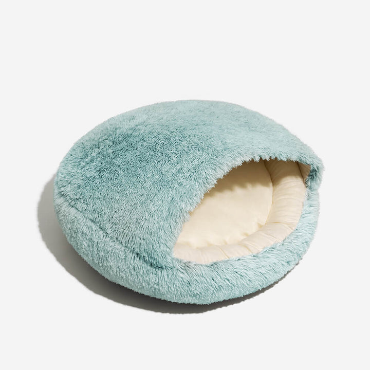 Washable calming dog bed, plush and semi-enclosed, shown in a home setting for pet relaxation.