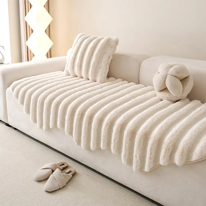 Angled shot of a plush sofa cover, illustrating its snug fit and protective qualities.