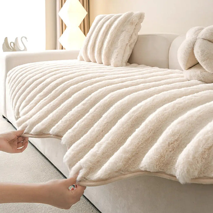 Beige plush sofa cover draped over a three-seater couch, ideal for pet-friendly homes.