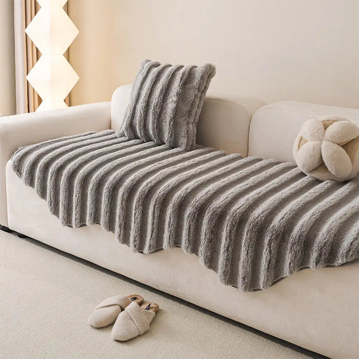 Close-up of plush sofa cover texture, highlighting its soft, pet-friendly fabric.