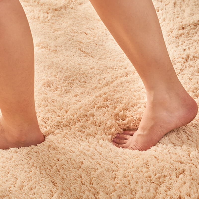 Corner detail of a green shaggy area rug, soft non-slip bedroom carpet texture, plush polyester.
