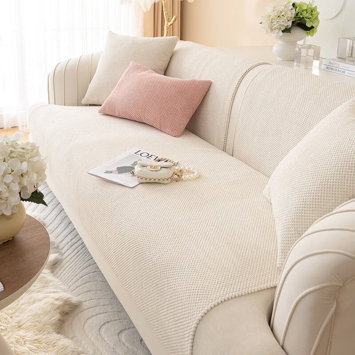 Stack of folded plush solid color sofa covers, available in various sizes for different couches