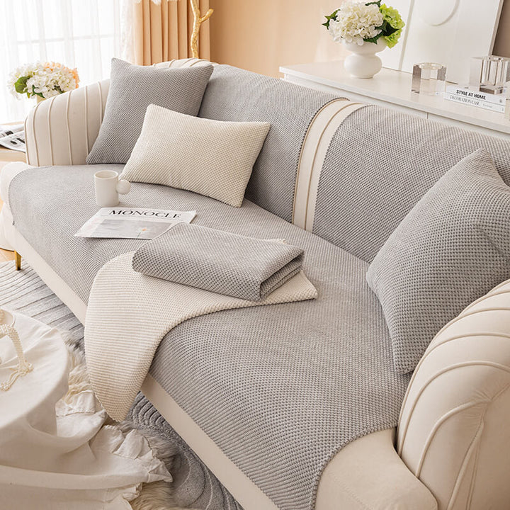 Back view of a plush solid color furniture protector on a sofa, showing full coverage and fit
