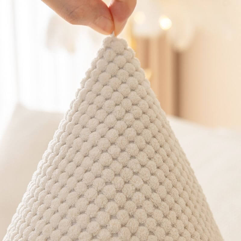 Non-slip backing visible on the plush solid color couch protector, securing it in place