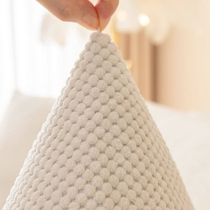 Non-slip backing visible on the plush solid color couch protector, securing it in place