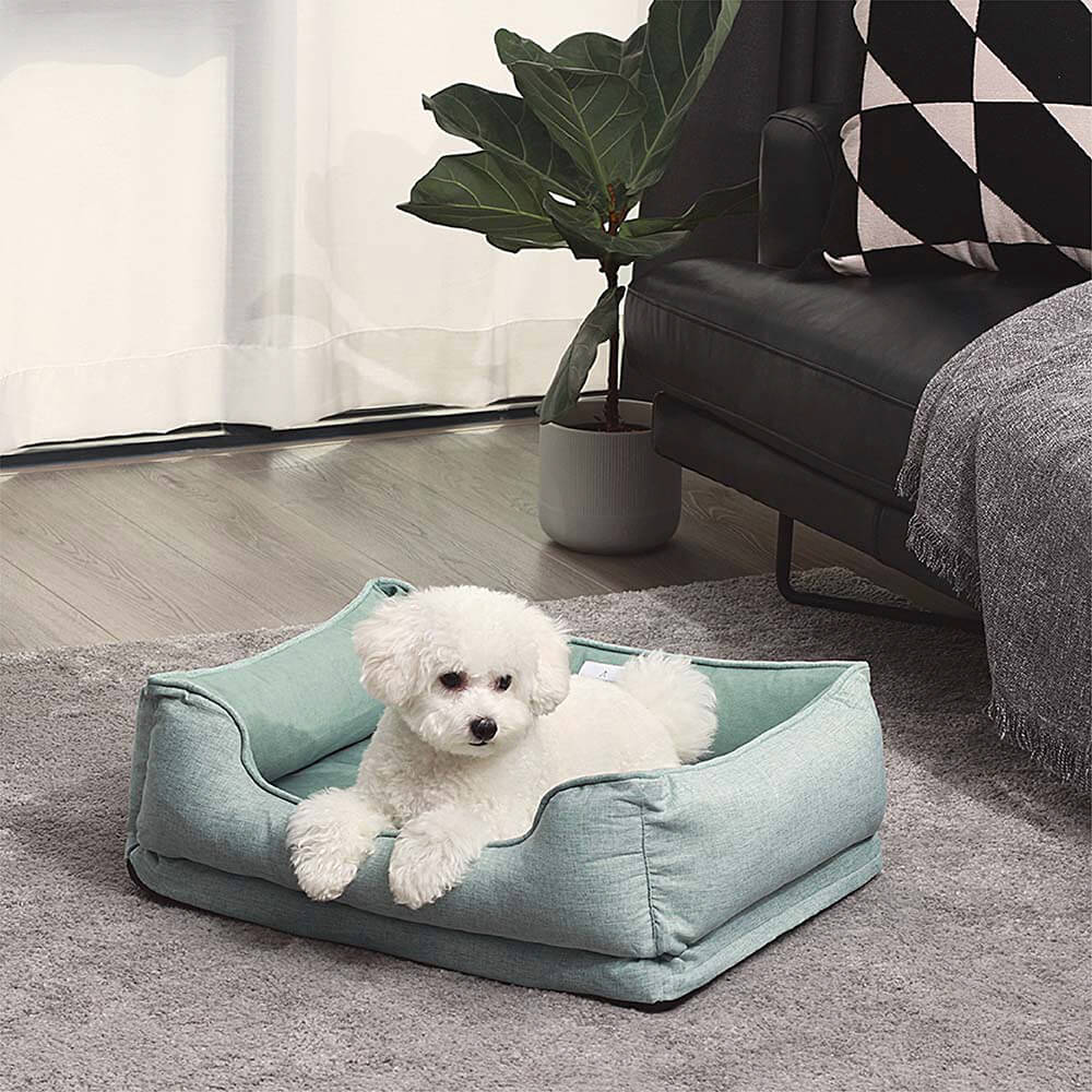 Small dog relaxing in a cozy plush square bread pet bed, washable design.