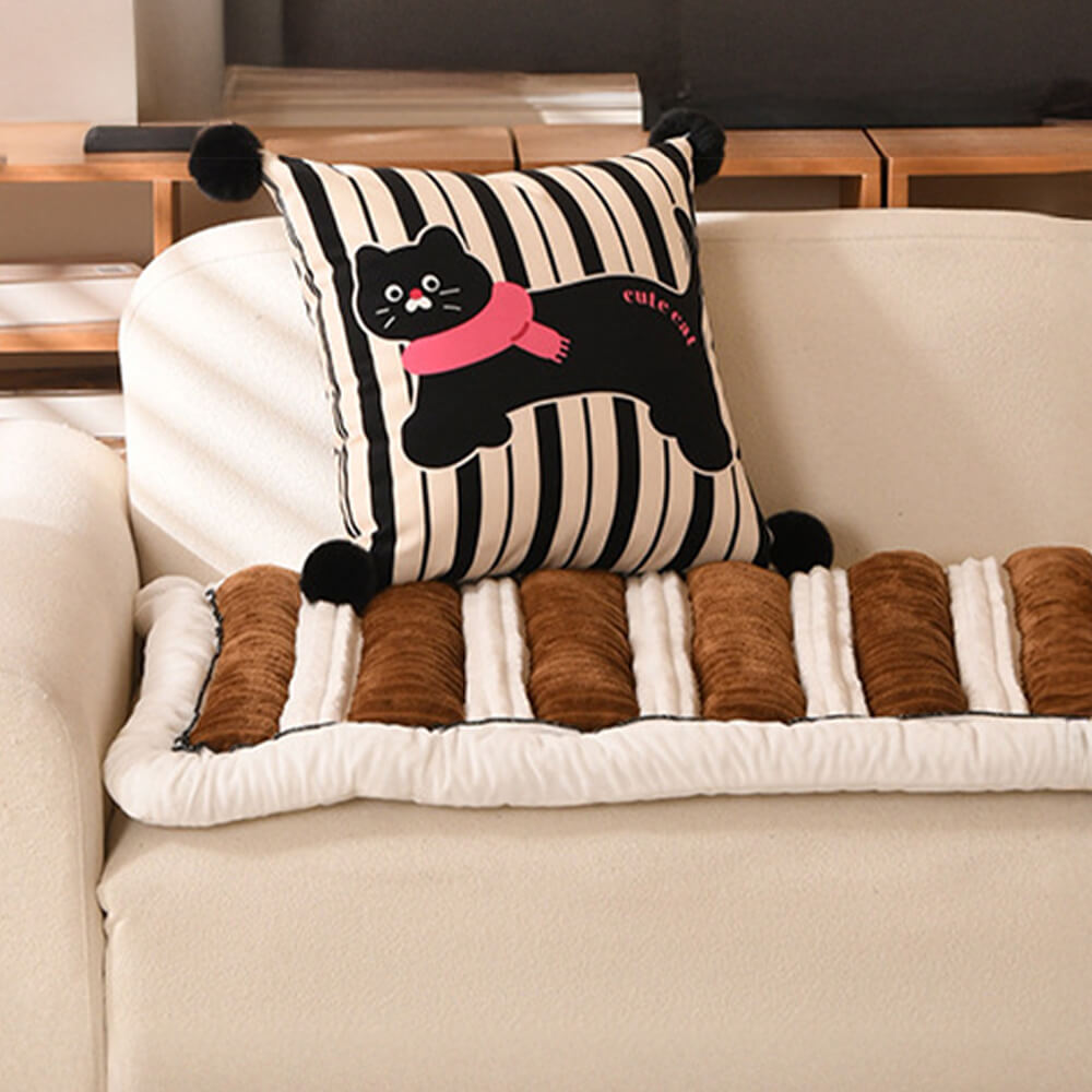 Detailed view of the anti-slip granular backing on a plush striped furniture protector for sofas.