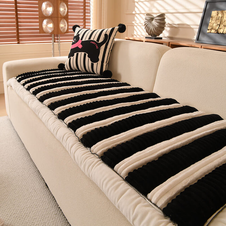 Full shot of a living room couch showcasing the striped non-slip plush sofa cover.