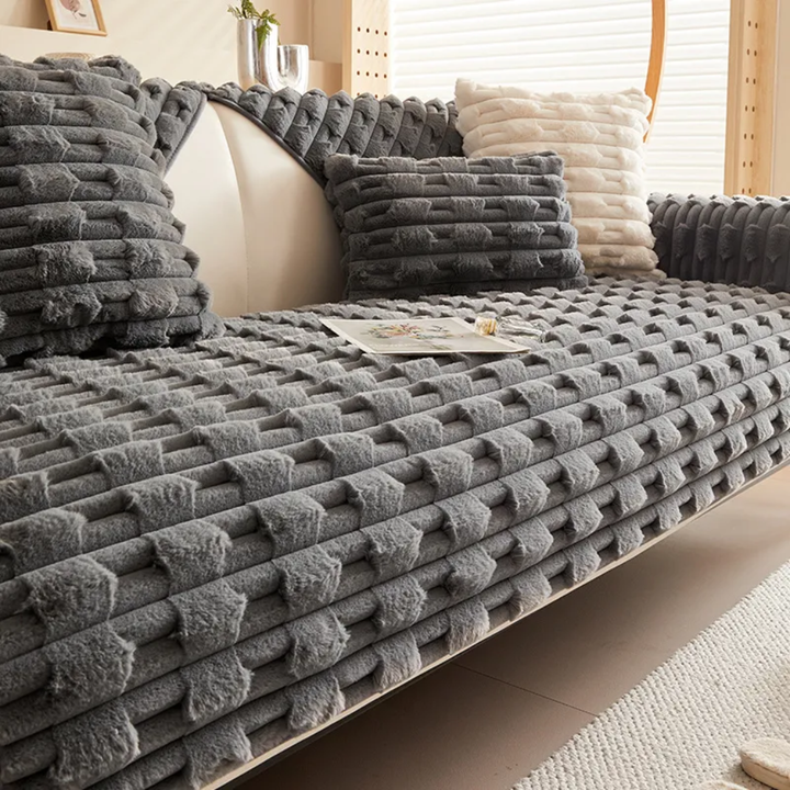 Plush striped sofa slipcover in neutral tones, protecting furniture from wear, tear, and spills