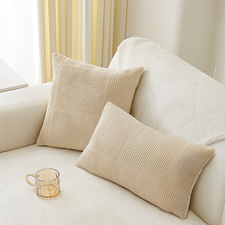 Plush striped square couch cover in a minimalist living room, adding warmth and style.