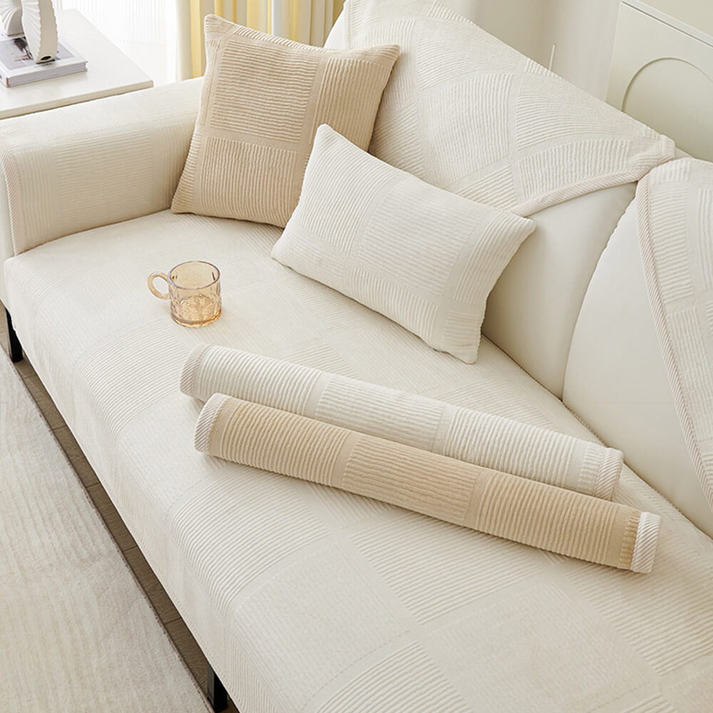 A family relaxing on a plush striped square sofa protected by an easy-clean slipcover.