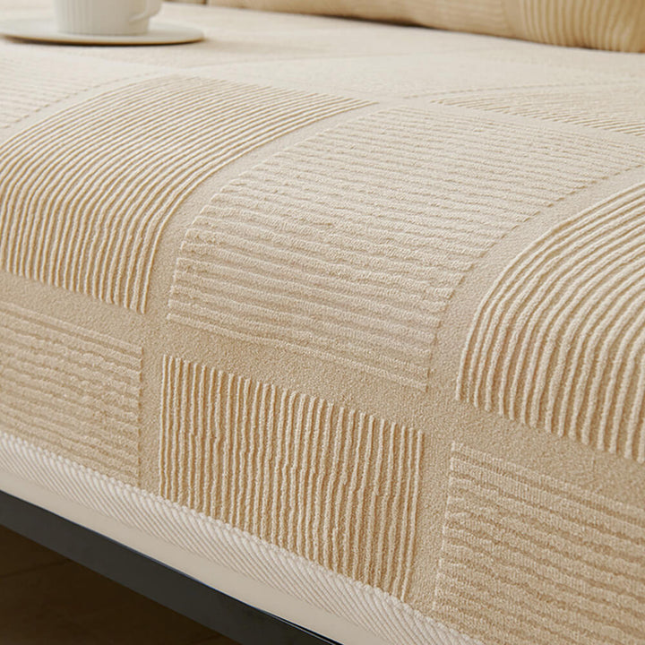 Detail of the non-slip backing on a plush striped square couch cover, secure fit.