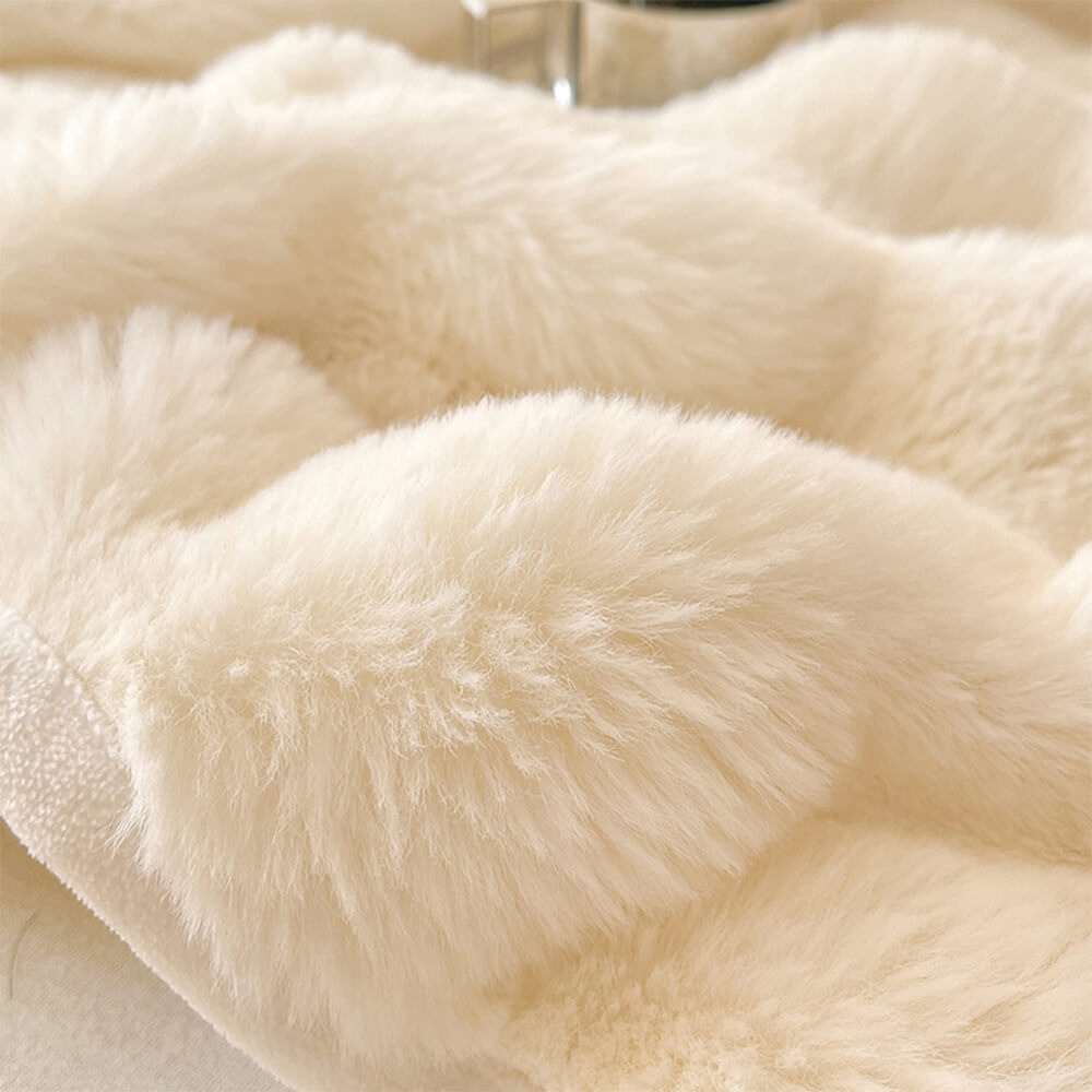 Close-up of the bubble texture on a plush velvet fitted sheet, showing its softness and quality.