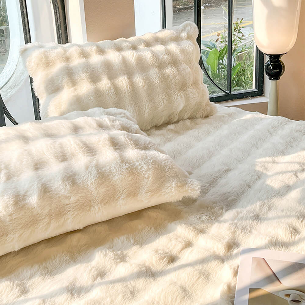 Unisex plush fitted sheet and pillowcases set, designed for ultimate comfort and warmth in any bedroom.