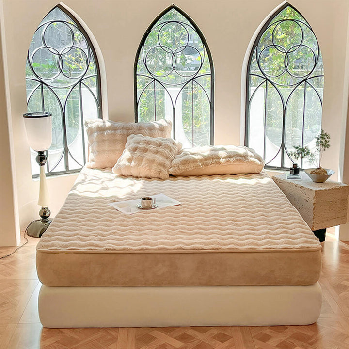 Bed showcasing a fitted velvet mattress cover with matching plush pillowcases, cozy and pet hair resistant.