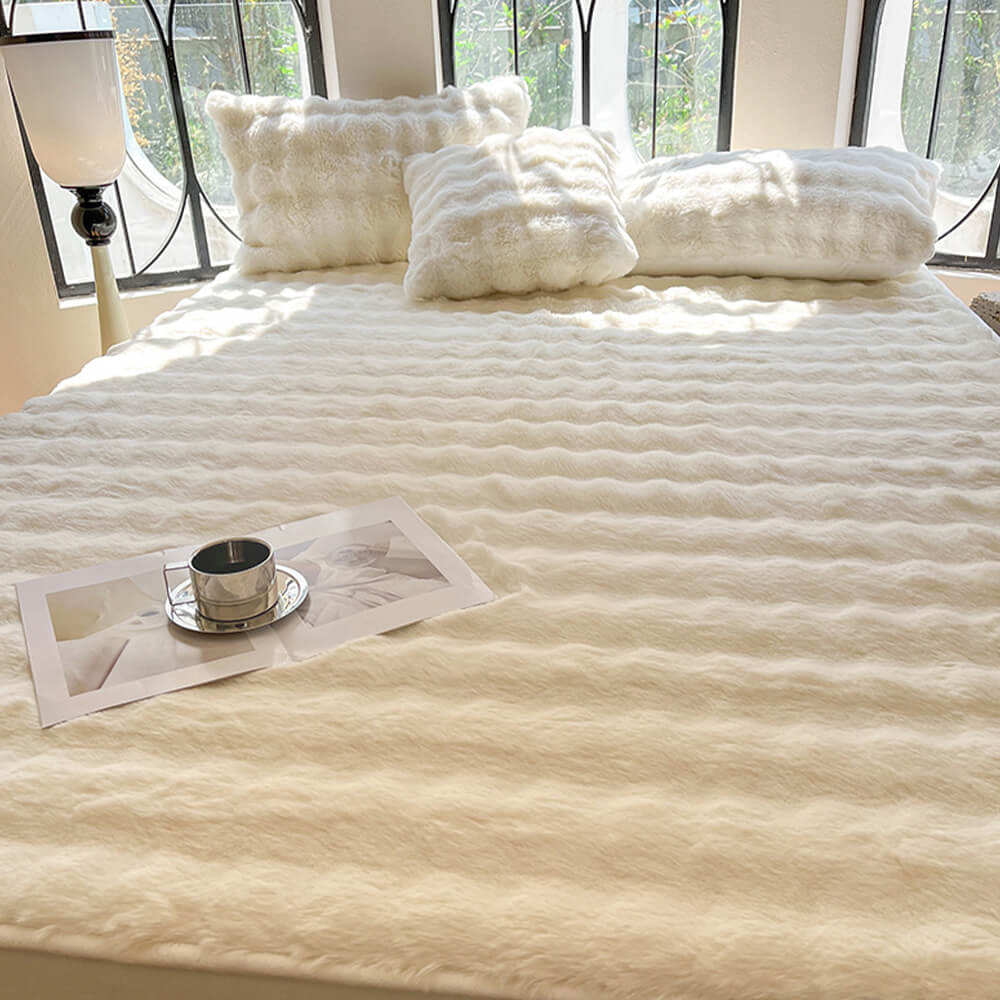 Corner of a bed with a fitted sheet, highlighting the plush bubble texture of the bedding, includes pillowcases.
