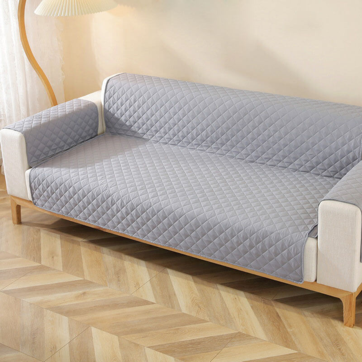 Stylish velvet sofa cover in a modern home, offering waterproof and non-slip furniture protection.