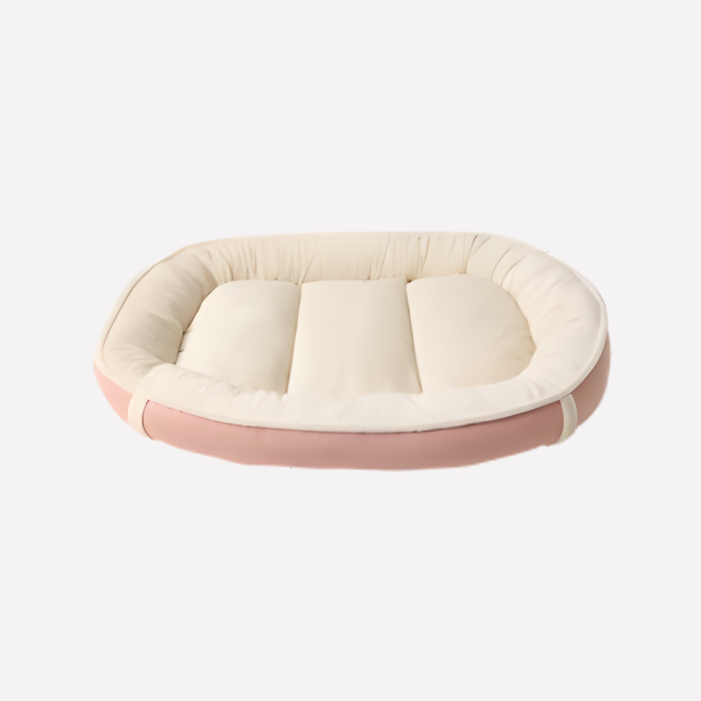 Beige nest dog bed with a removable cover and supportive raised edges, perfect for pet comfort and easy cleaning.