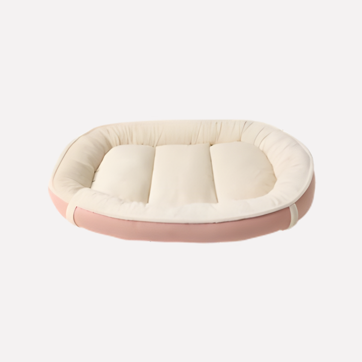 Beige nest dog bed with a removable cover and supportive raised edges, perfect for pet comfort and easy cleaning.