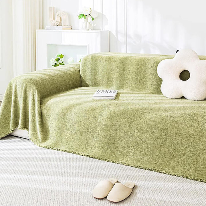 Corner detail of a plush water-resistant couch cover, demonstrating its snug fit and protection.