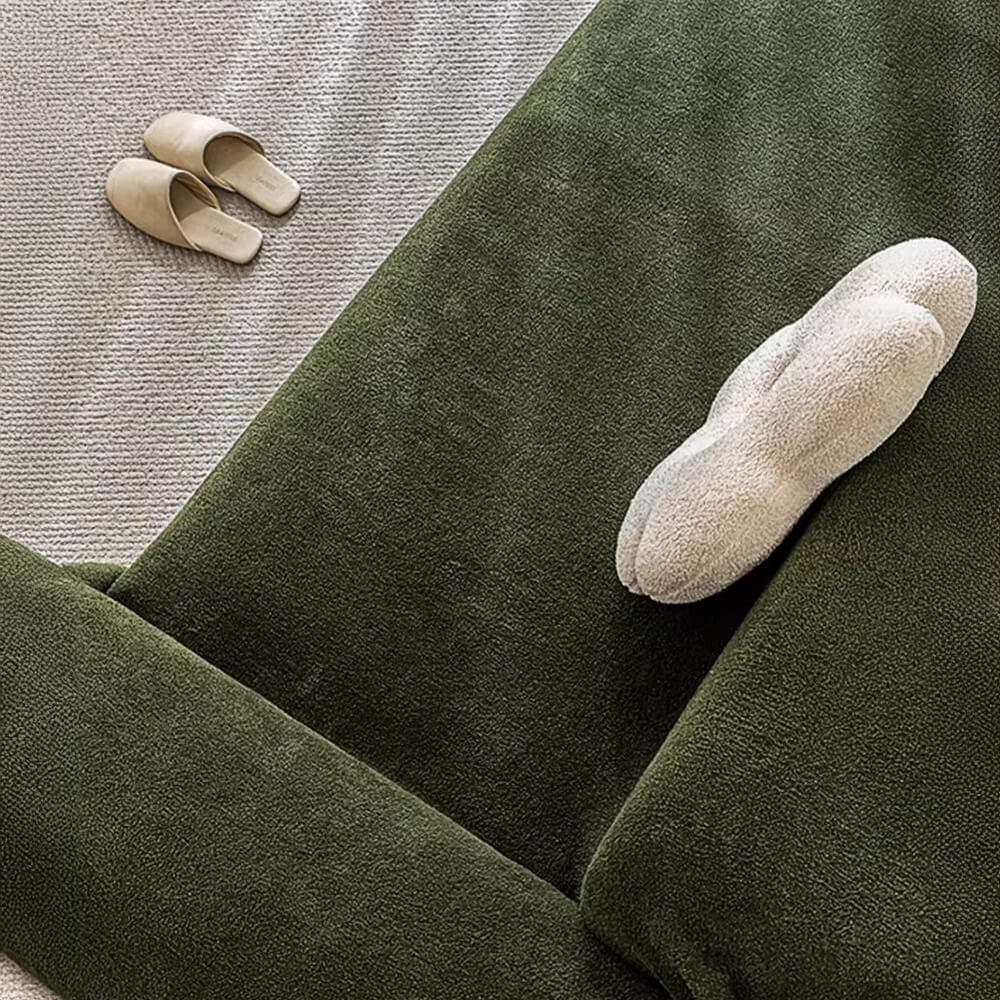 Stylish plush water-resistant couch protector in contemporary blue, enhancing home decor.