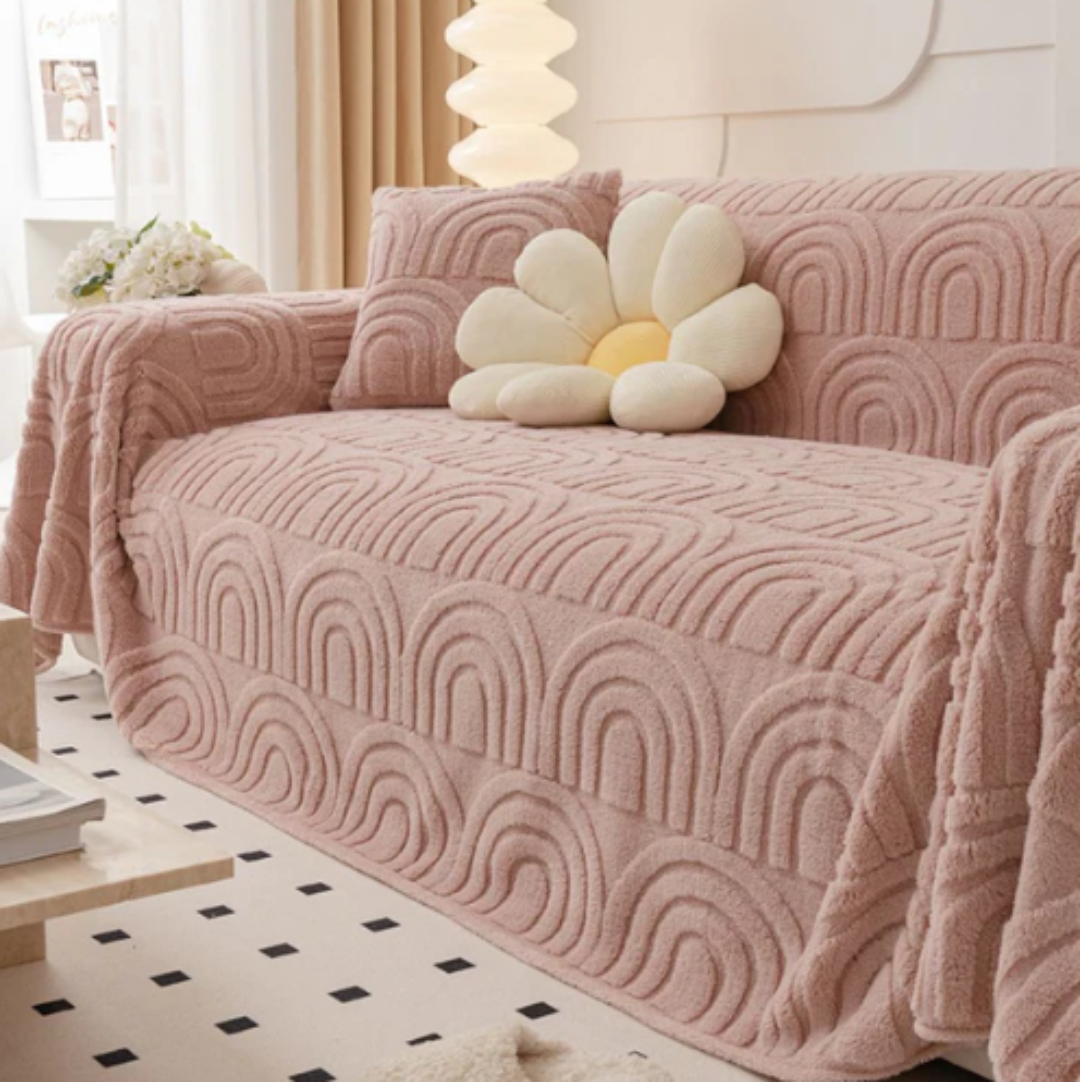 Corner view of a modern sofa protected by a plush wave pattern cover, showcasing its anti-slip feature and style.