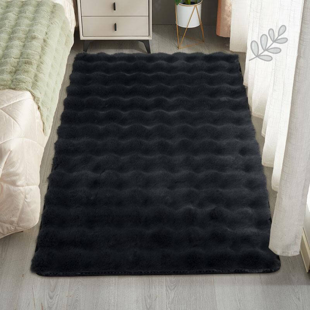 Full view of a rectangular faux sheepskin area rug, shaggy texture for home decor