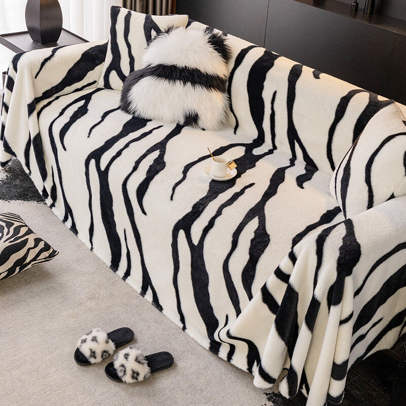Washable zebra pattern sofa protector draped over a two-seater couch, chic home decor