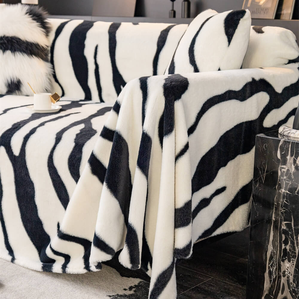 Full view of a zebra striped plush couch cover, offering stylish furniture protection