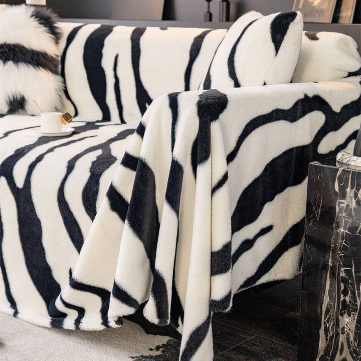 Full view of a zebra striped plush couch cover, offering stylish furniture protection