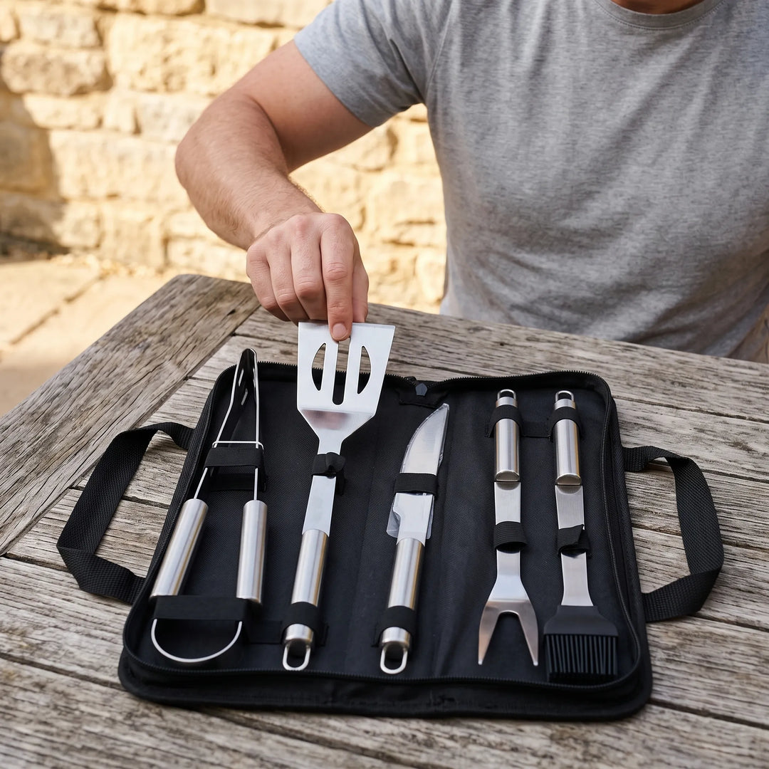 Portable BBQ grilling tool set with stainless steel utensils in a compact travel case, perfect for camping.