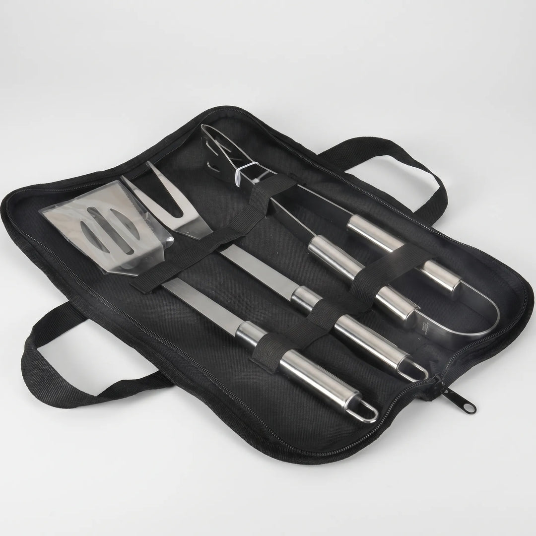 Essential grilling tool set including a spatula, fork, and tongs, packed in a sturdy portable travel case.