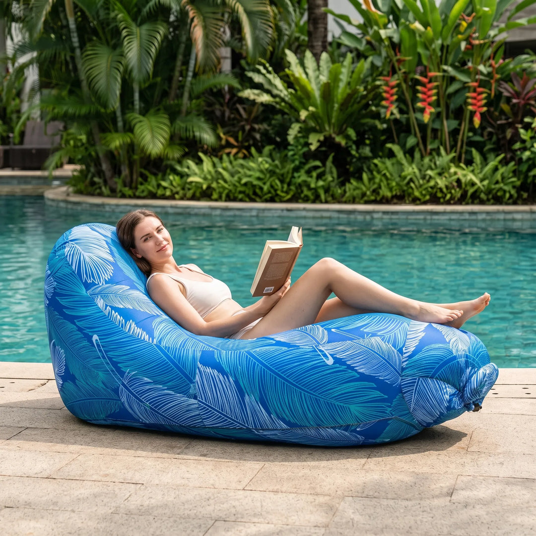 Portable inflatable outdoor lounge chair for comfortable relaxation in garden or camping. Easy setup beach lounger.