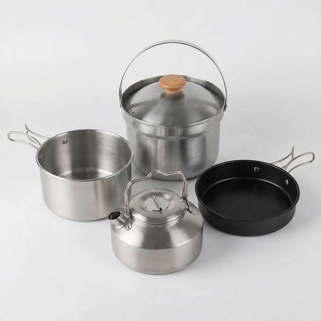 Nesting camp kitchen cookware set for outdoor cooking. Includes portable pot, frying pan, and kettle for adventurers.