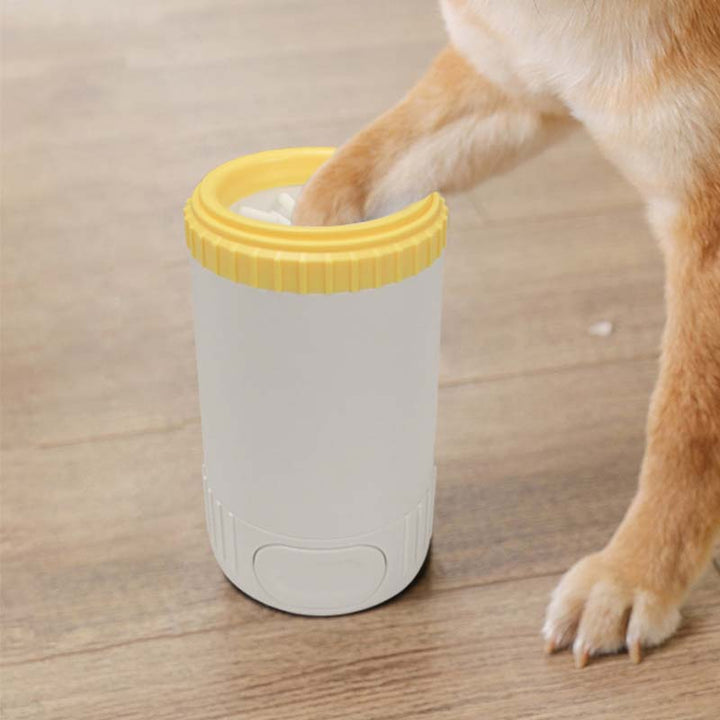 Close-up of a portable dog paw cleaner showing soft silicone brush for effective mud removal and pet care.