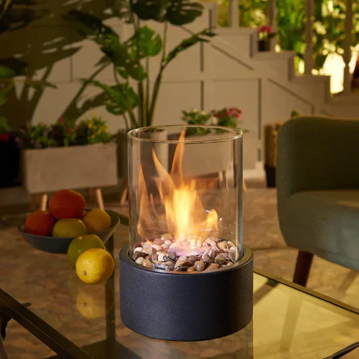 Portable tabletop fire lantern, steel & glass, for indoor/outdoor ambiance.
