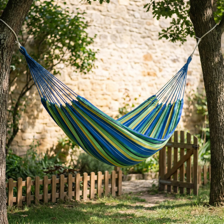 Portable travel hammock, light canvas, for outdoor relaxation & camping. Easy setup in nature.
