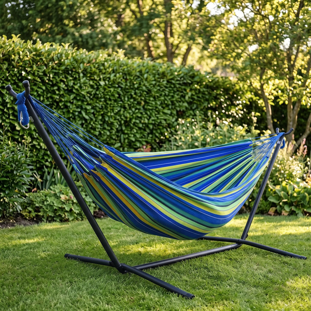 Striped canvas hammock for garden leisure. Perfect portable outdoor relaxation in your backyard or park.