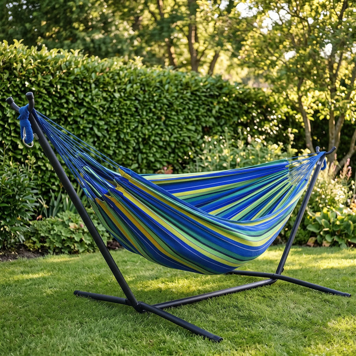 Striped canvas hammock for garden leisure. Perfect portable outdoor relaxation in your backyard or park.