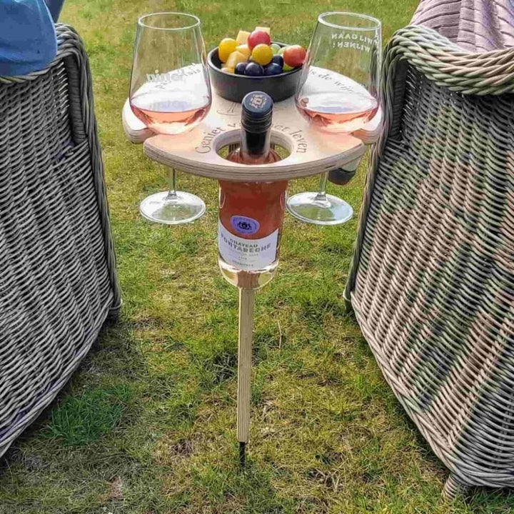 Portable wooden wine table with integrated wine glass holders & snack board for picnics, garden parties, or beach.
