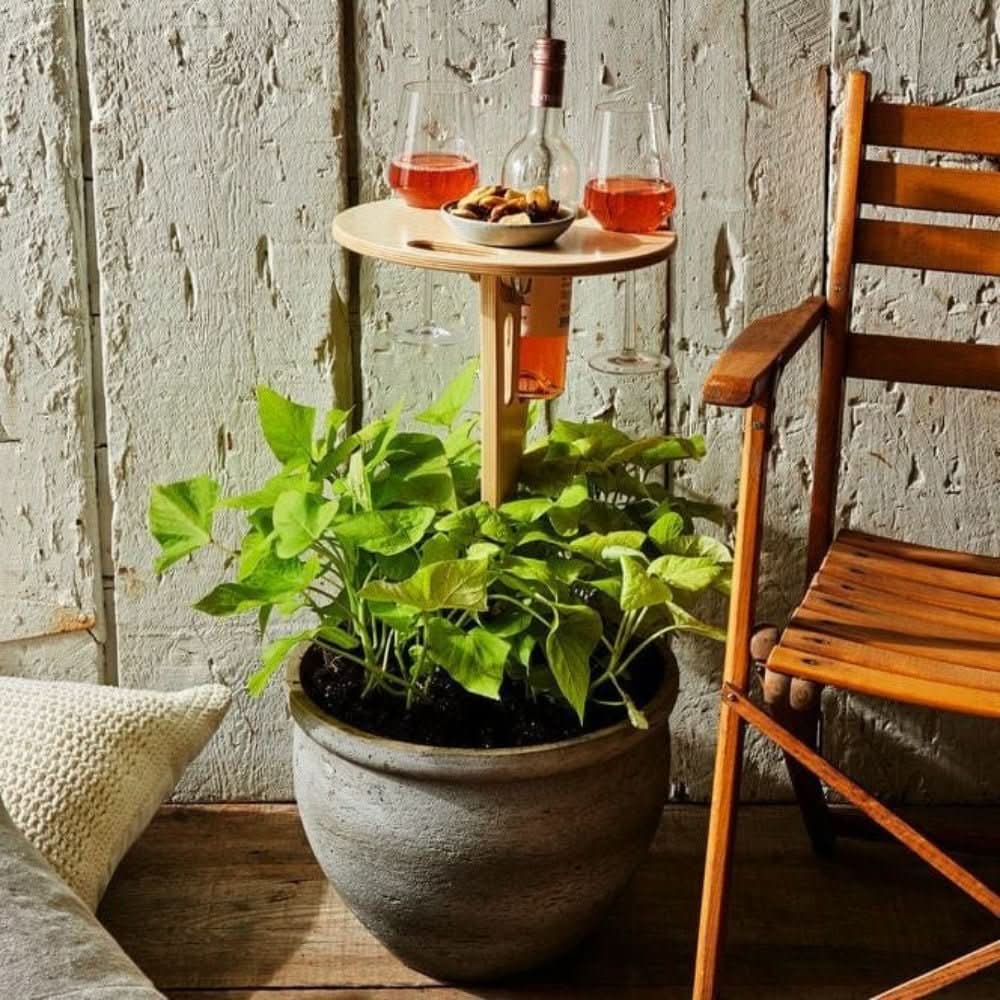 Compact folding outdoor wine table, perfect for holding wine bottles, glasses & snacks during camping or beach trips.